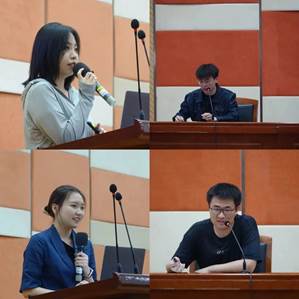 一群人看着桌子上的电脑描述已自动生成